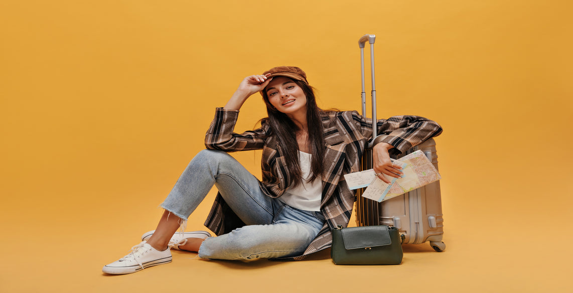 brunette-young-woman-beret-white-tee-coat-jeans-looks-into-camera-smiles-stylish-girl-sits-floor-leans-suitcase-holds-map-isolated