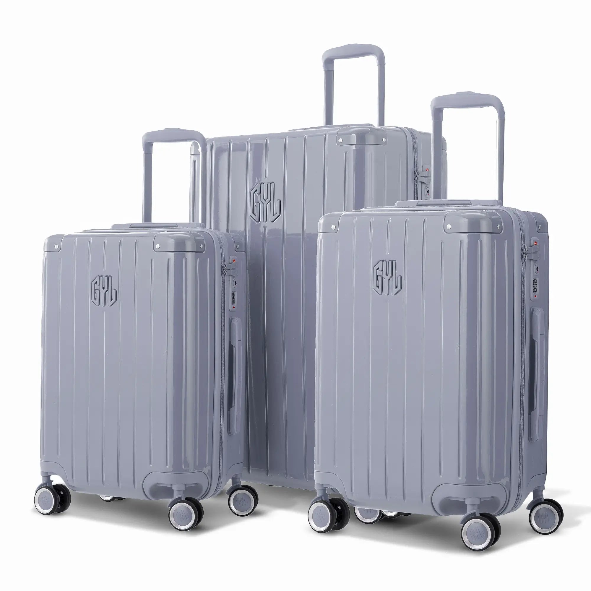 Trio de valises rigides GYL Intemporelle argent avec coques nervurées et poignées télescopiques.