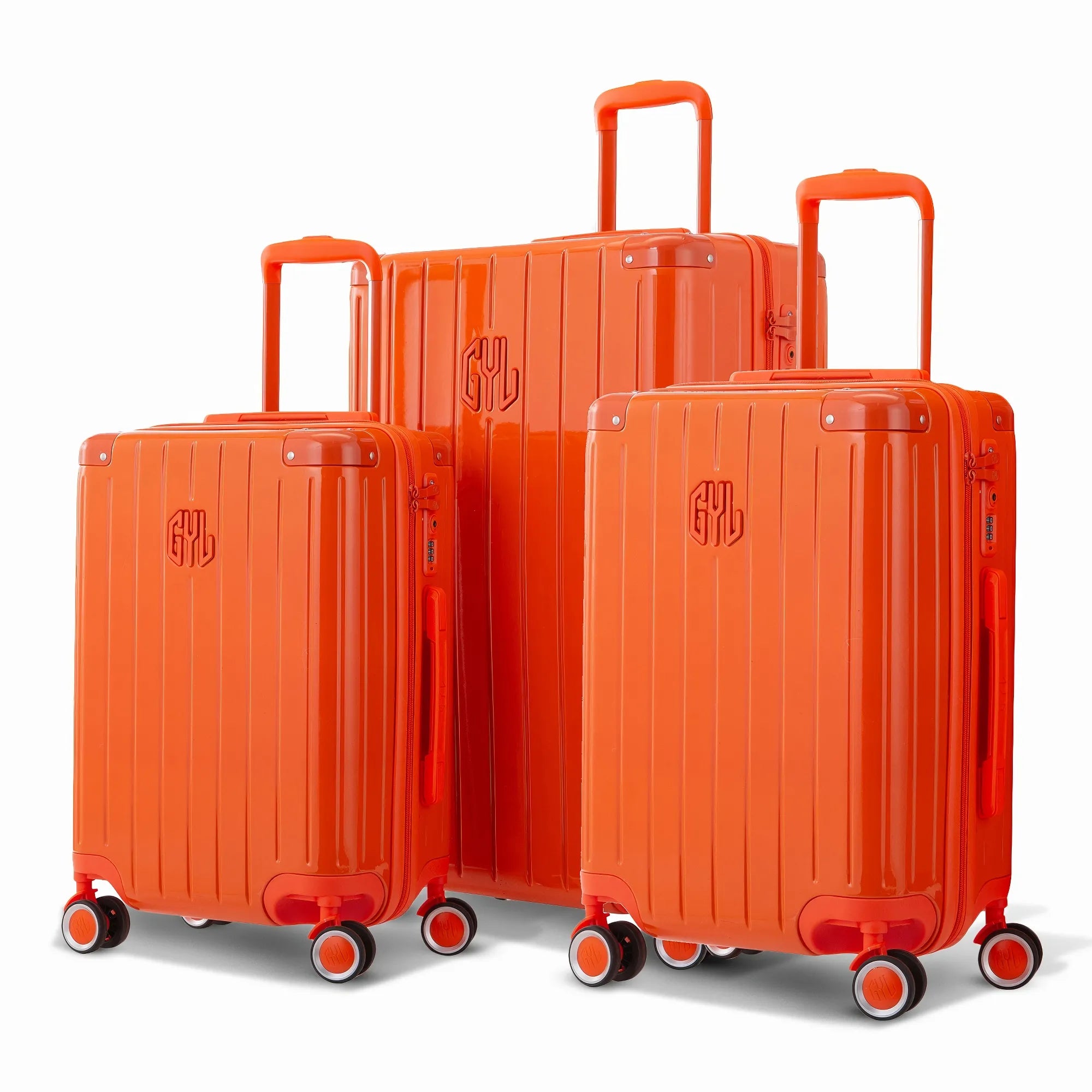 Trio de valises rigides GYL Intemporelle orange avec coques nervurées et poignées télescopiques.