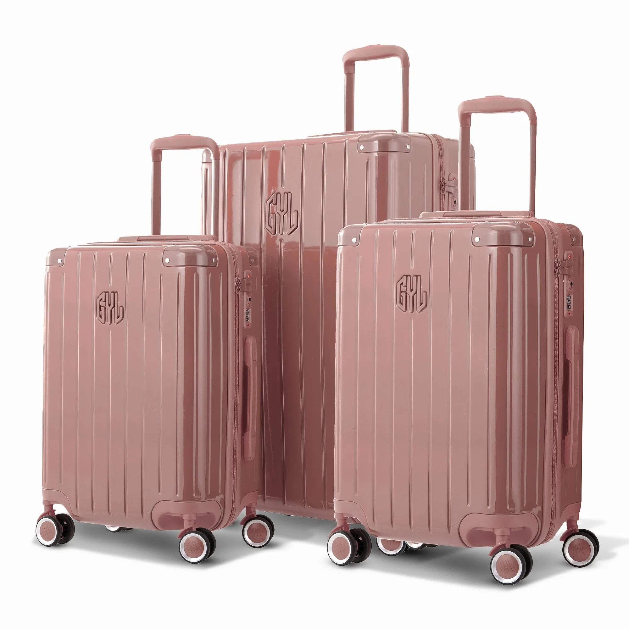 Trio de valises rigides GYL Intemporelle rose gold avec coques nervurées et poignées télescopiques.