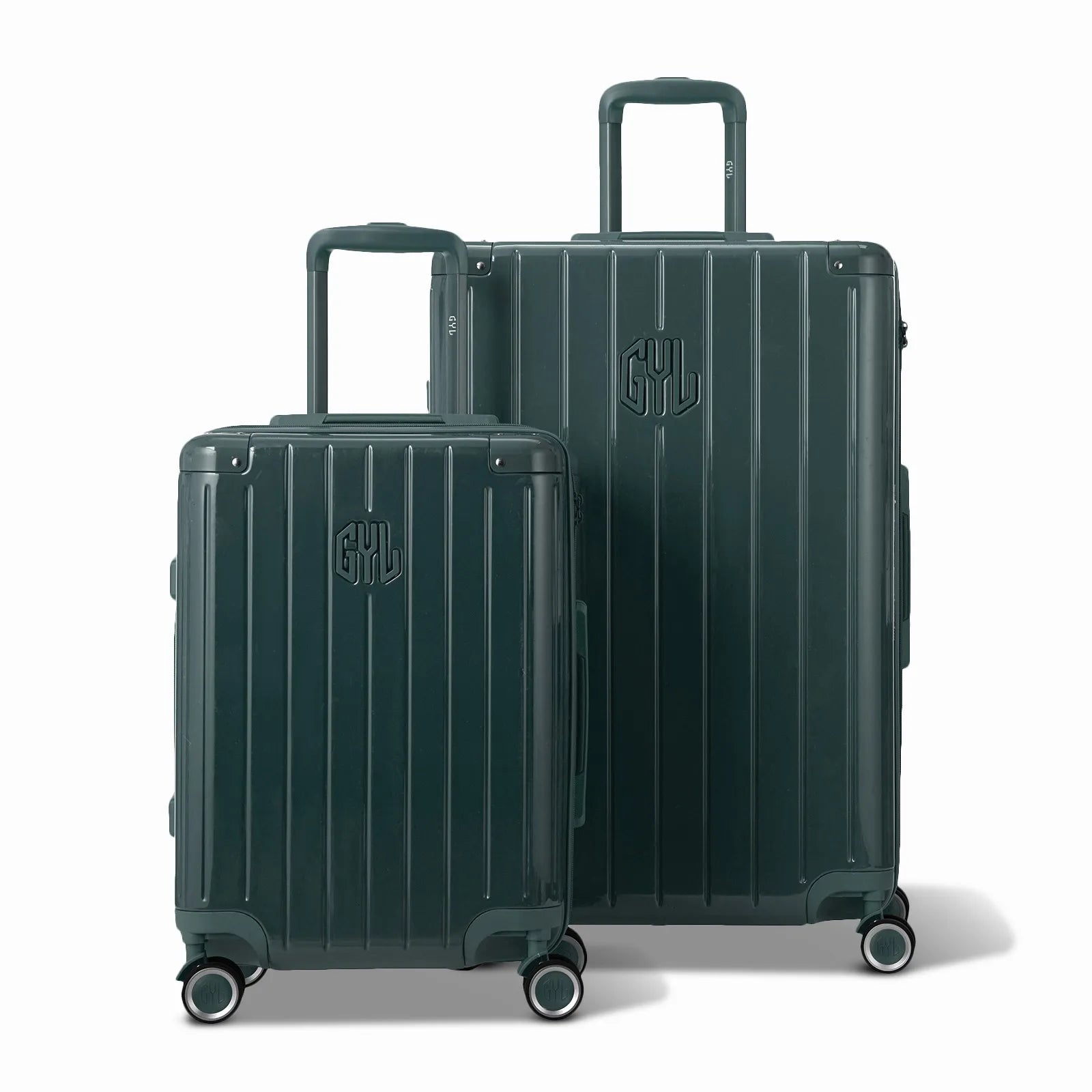 Deux valises rigides GYL Intemporelle gris foncé, format cabine et soute, avec poignée trolley déployée.