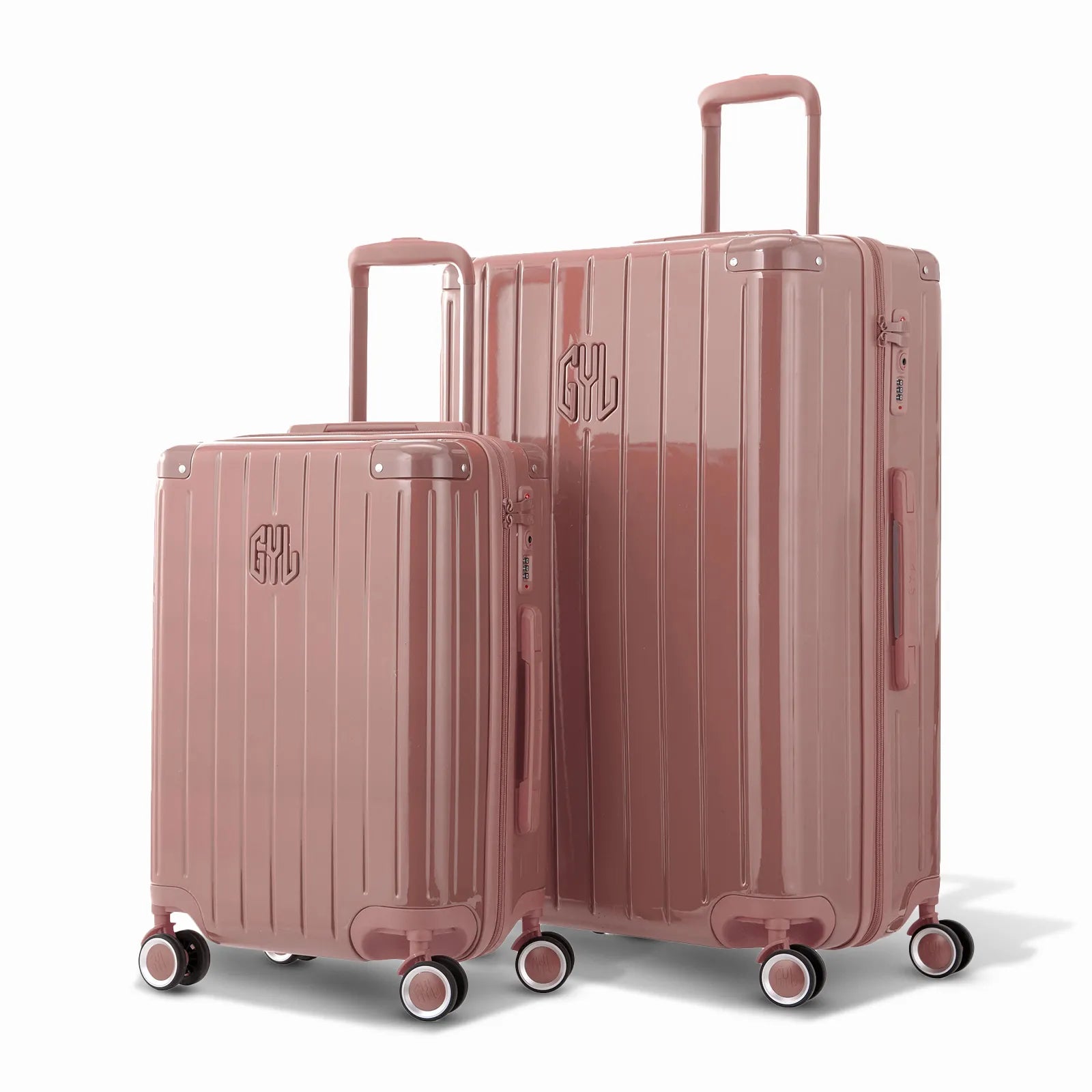 Duo de valises rigides GYL Intemporelle rose gold avec coques nervurées et poignées télescopiques.