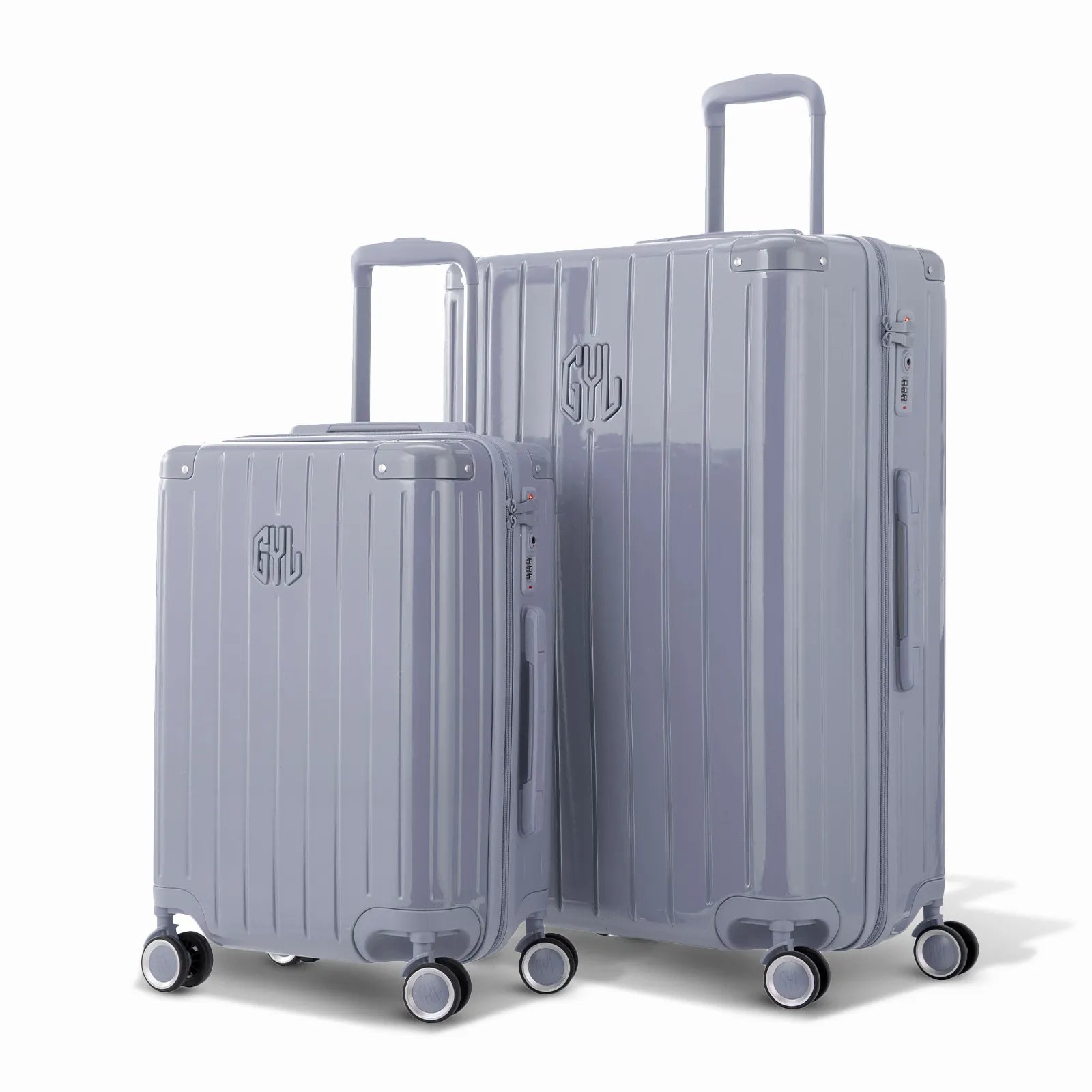 Duo de valises rigides GYL Intemporelle argent avec coques nervurées et poignées télescopiques.