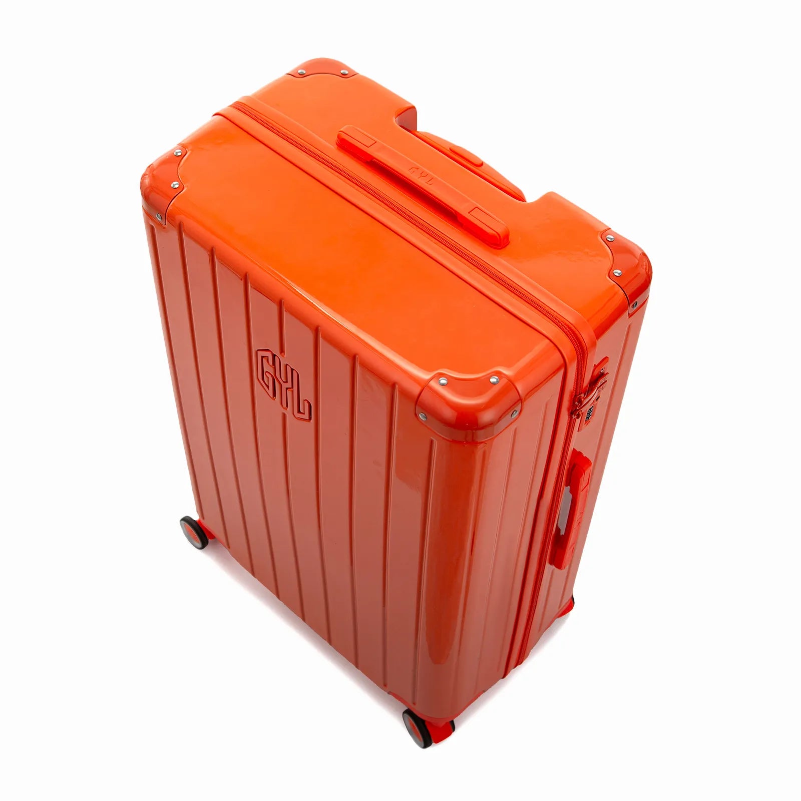 Vue en angle de la valise rigide GYL Intemporelle orange avec coins renforcés et coque nervurée brillante.
