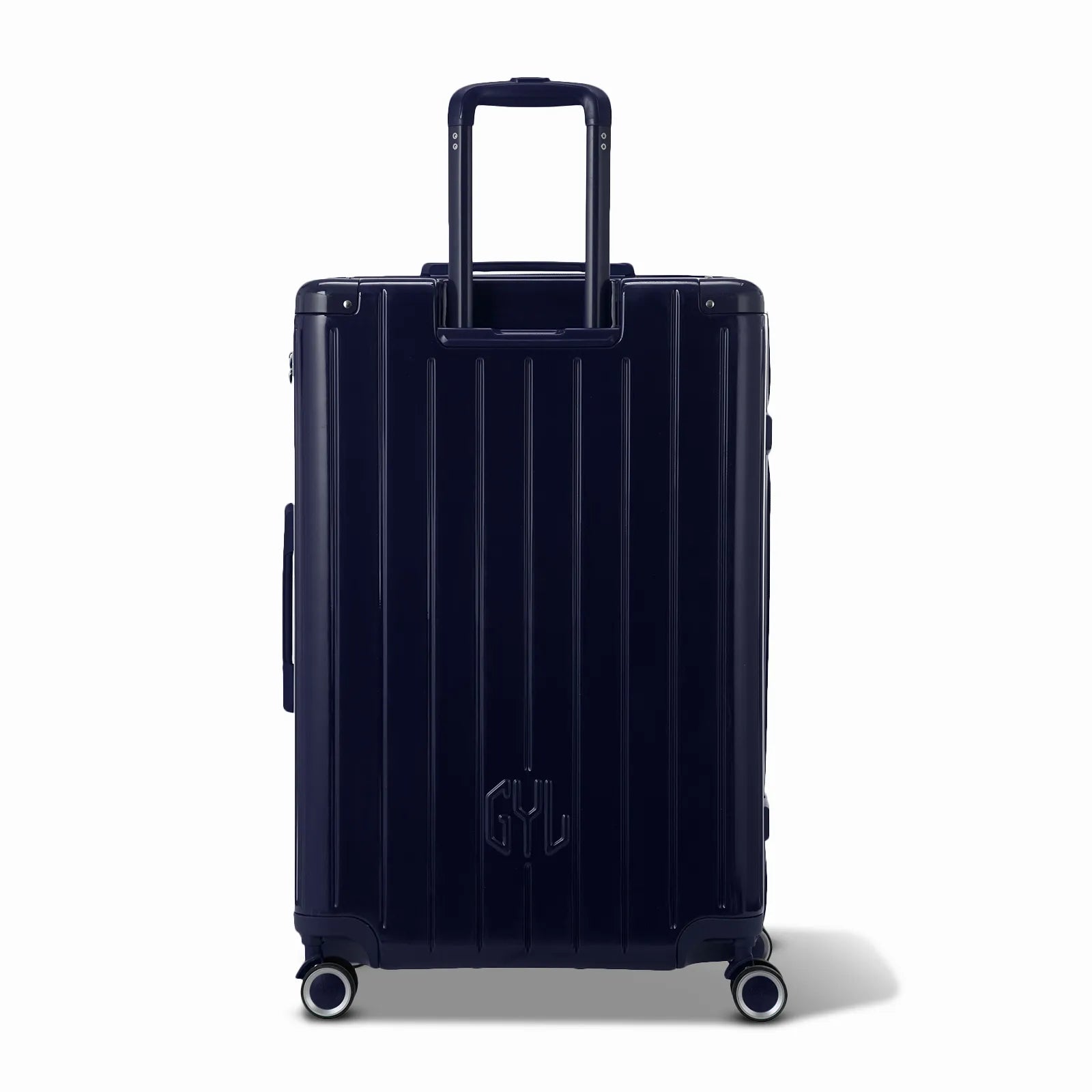 Vue arrière de la valise rigide GYL Intemporelle marine avec poignées intégrées et roulettes pivotantes.
