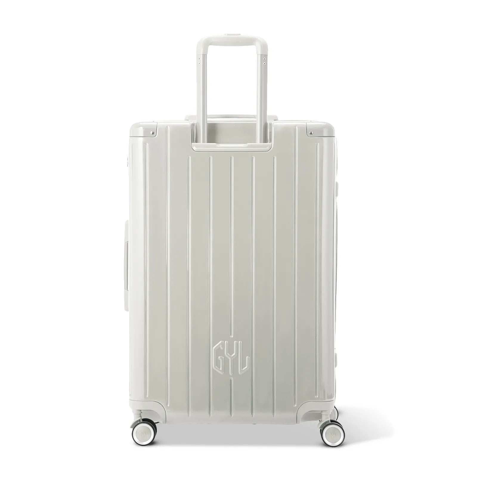 Vue arrière de la valise rigide GYL Intemporelle sable avec poignées intégrées et roulettes pivotantes.