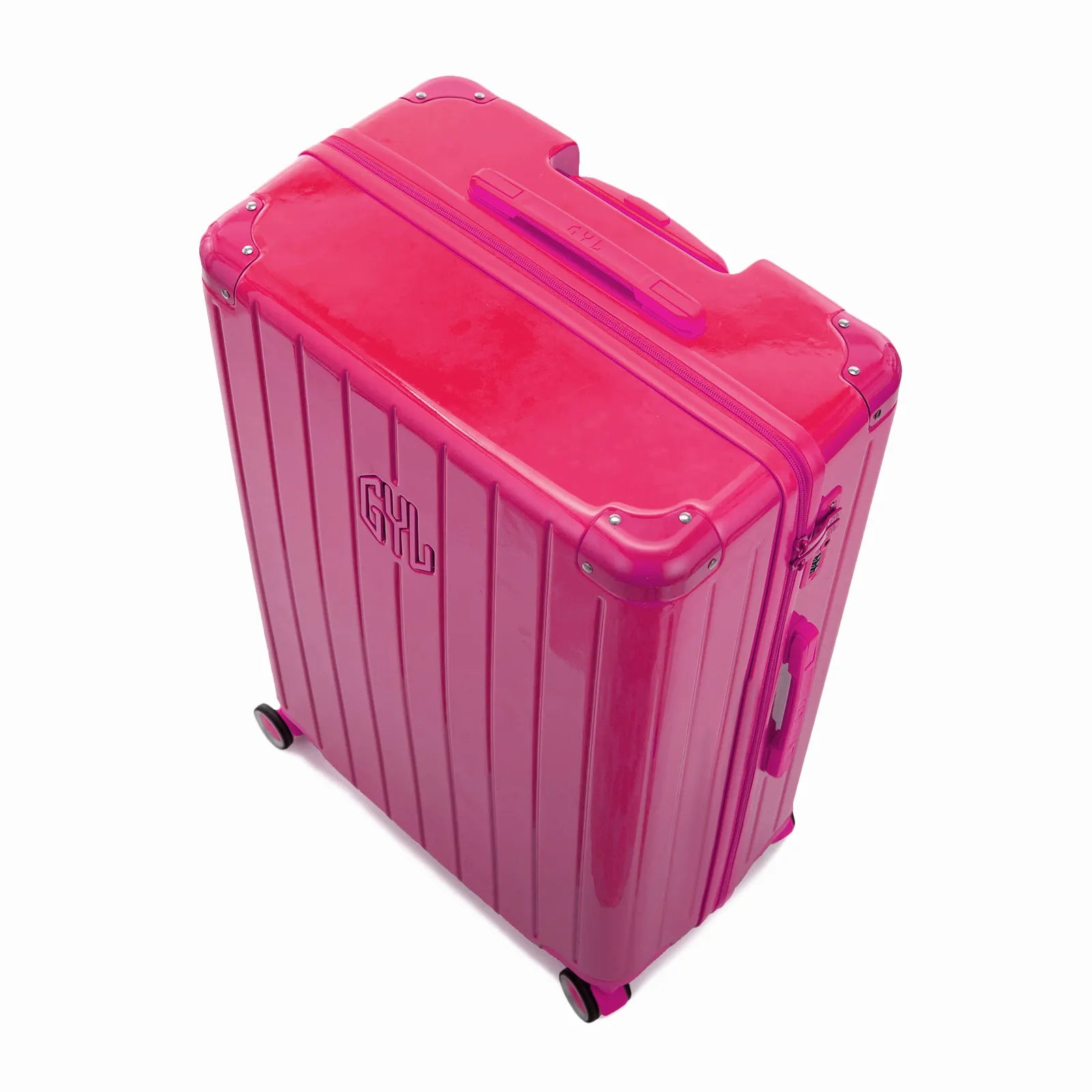 Vue en angle de la valise rigide GYL Intemporelle fuchsia avec coins renforcés et coque nervurée brillante.