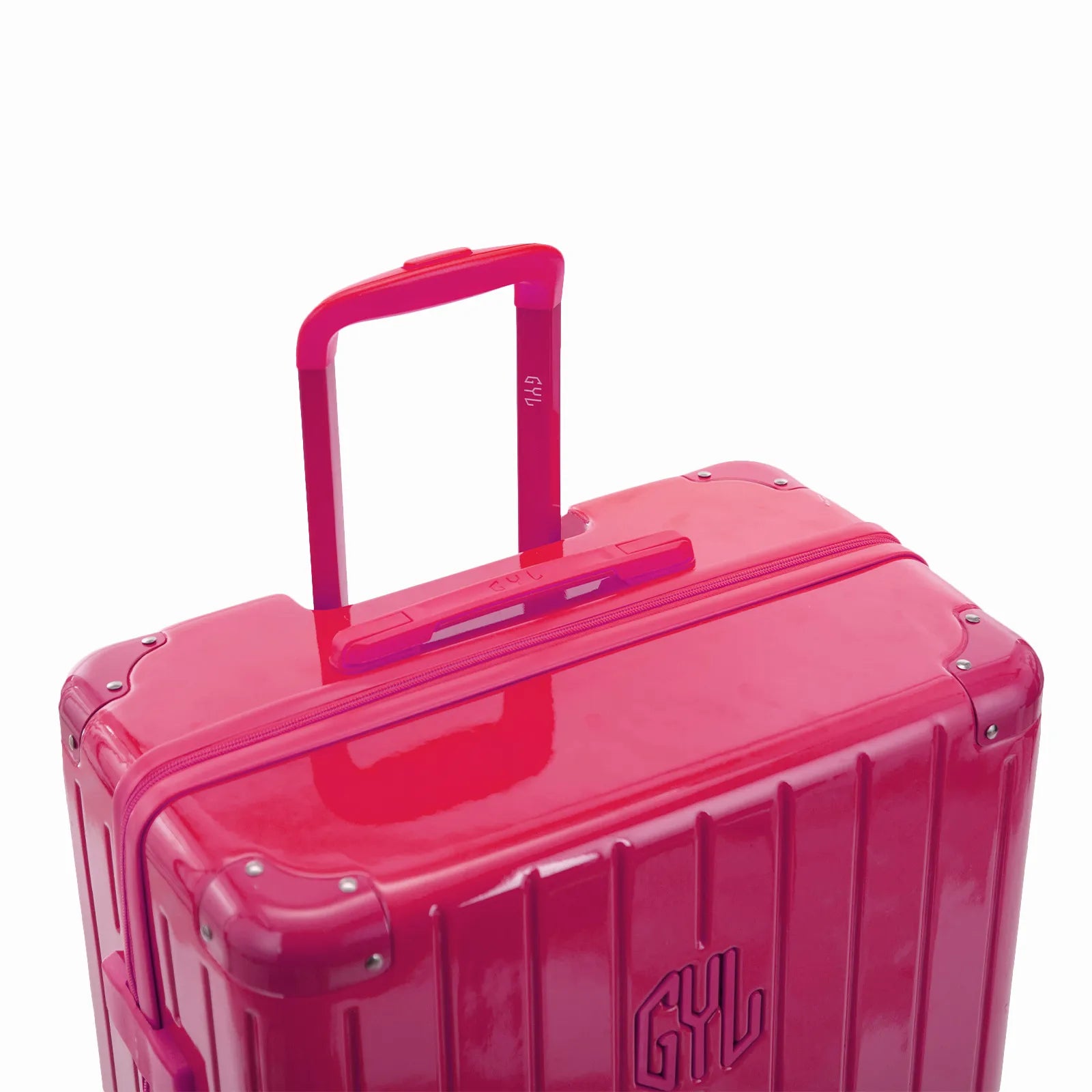 Poignée trolley télescopique GYL déployée sur la valise Intemporelle fuchsia en polycarbonate.