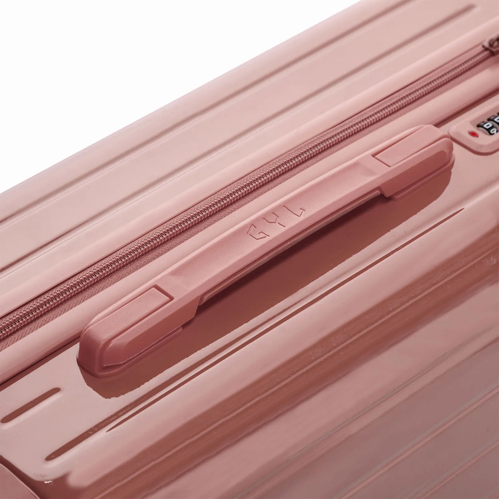 Poignée supérieure rigide de la valise GYL Intemporelle rose gold avec logo embossé sur le dessus.