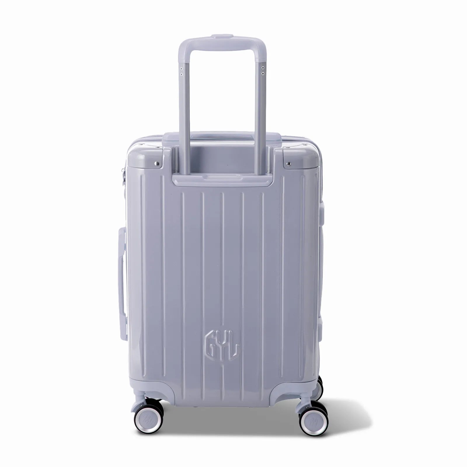Vue arrière de la valise rigide GYL Intemporelle argent avec poignées intégrées et roulettes pivotantes.