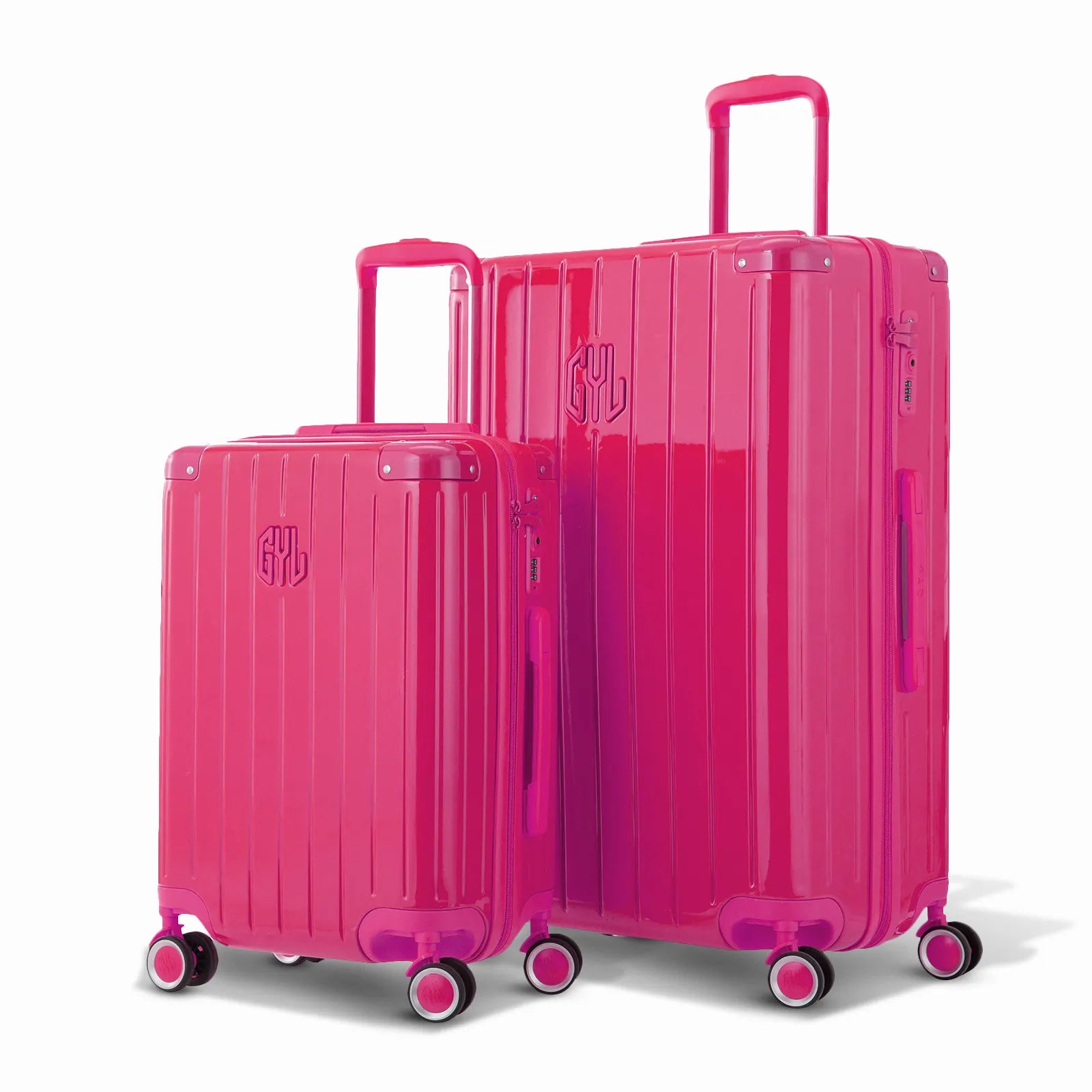 Duo de valises rigides GYL Intemporelle fuchsia avec coques nervurées et poignées télescopiques.