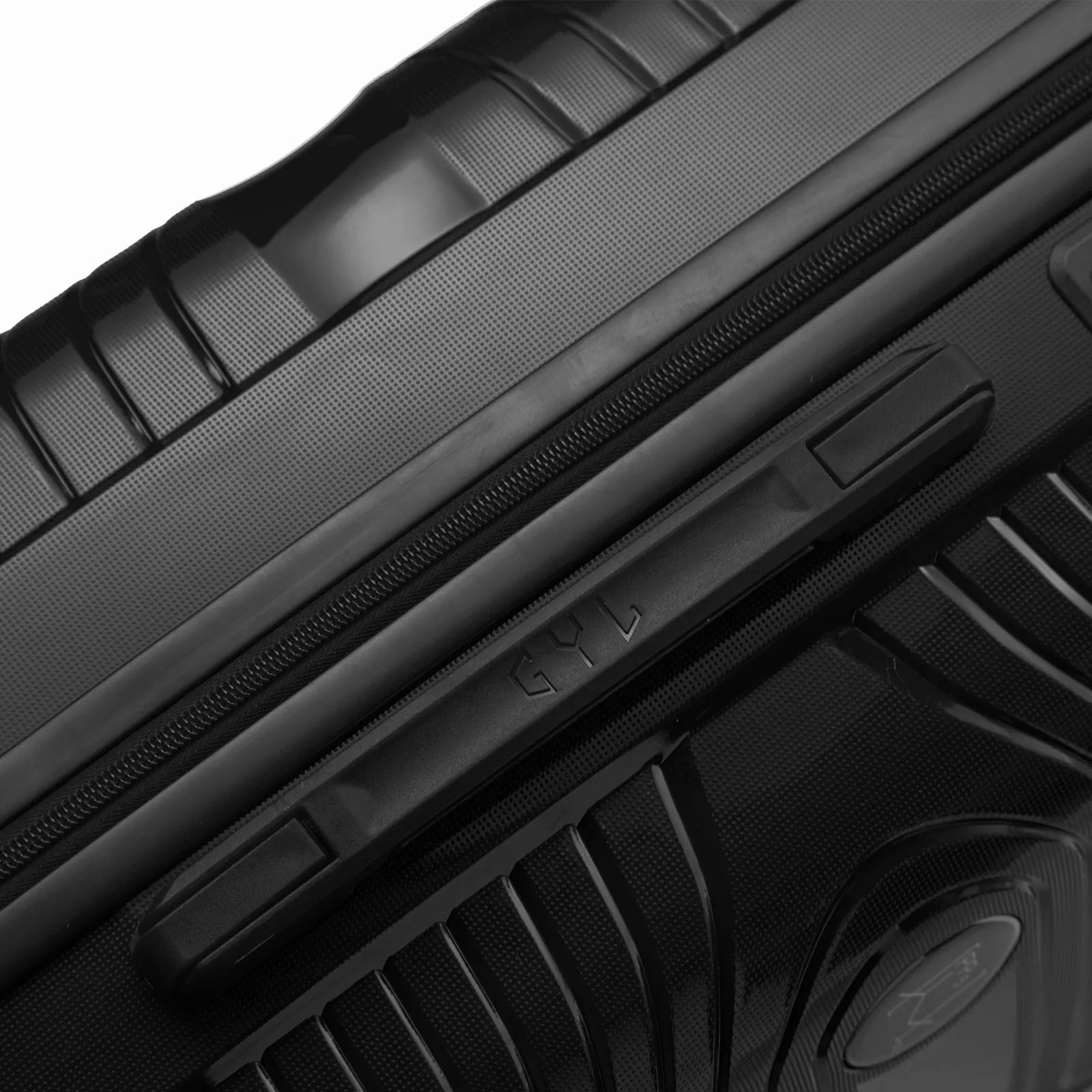 Détail de la poignée latérale et du logo GYL sur la valise Signature rouge.