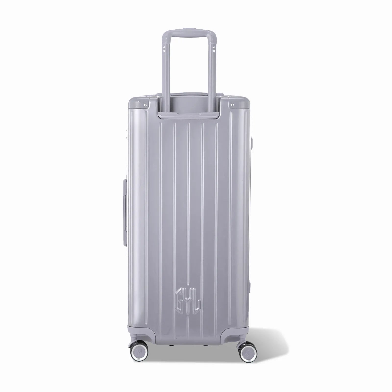 Dos de la valise trunk GYL XL argent avec trolley télescopique sorti et logo embossé.