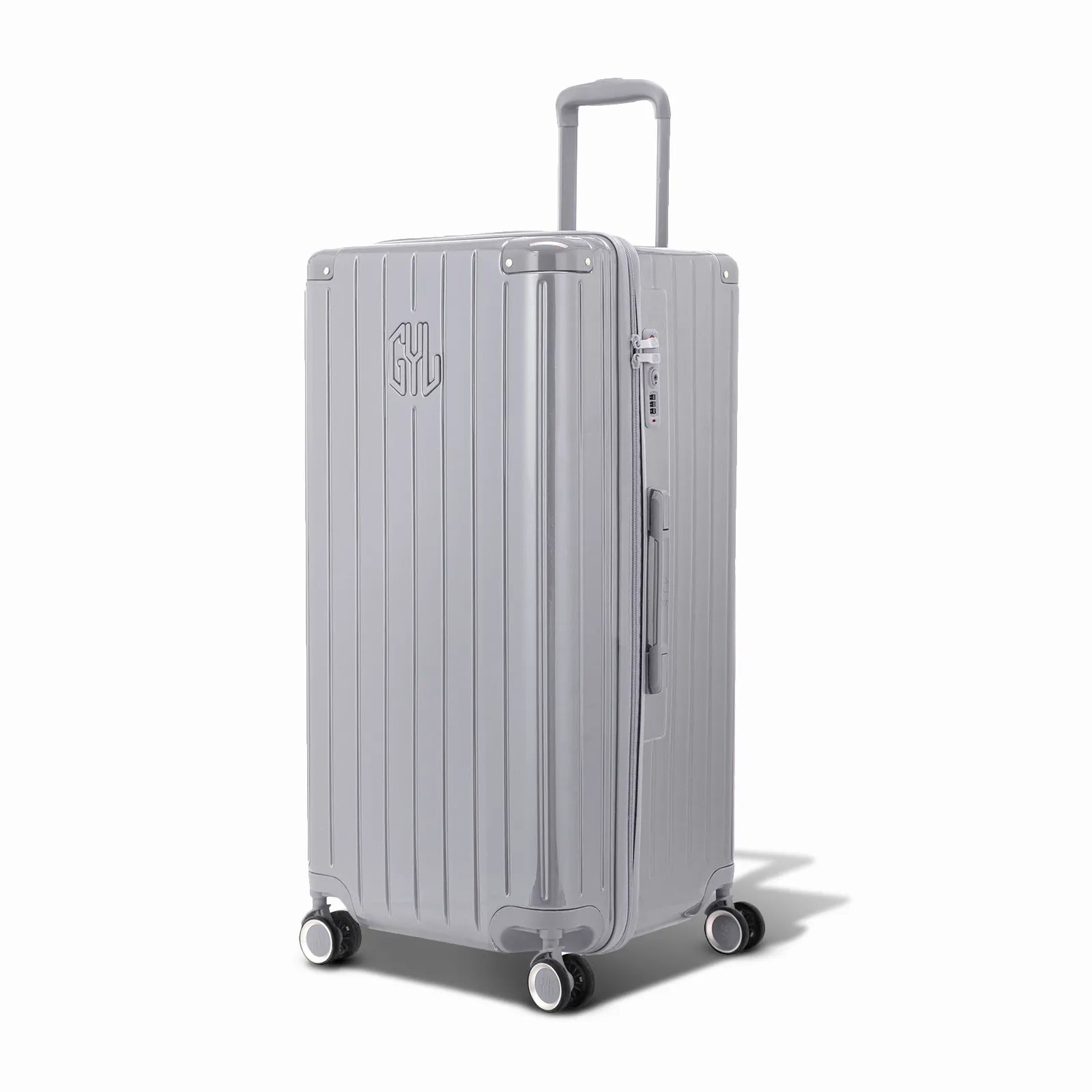 Valise trunk GYL taille XL en polycarbonate argent vue de trois quarts, avec trolley déployé et roues 360°.