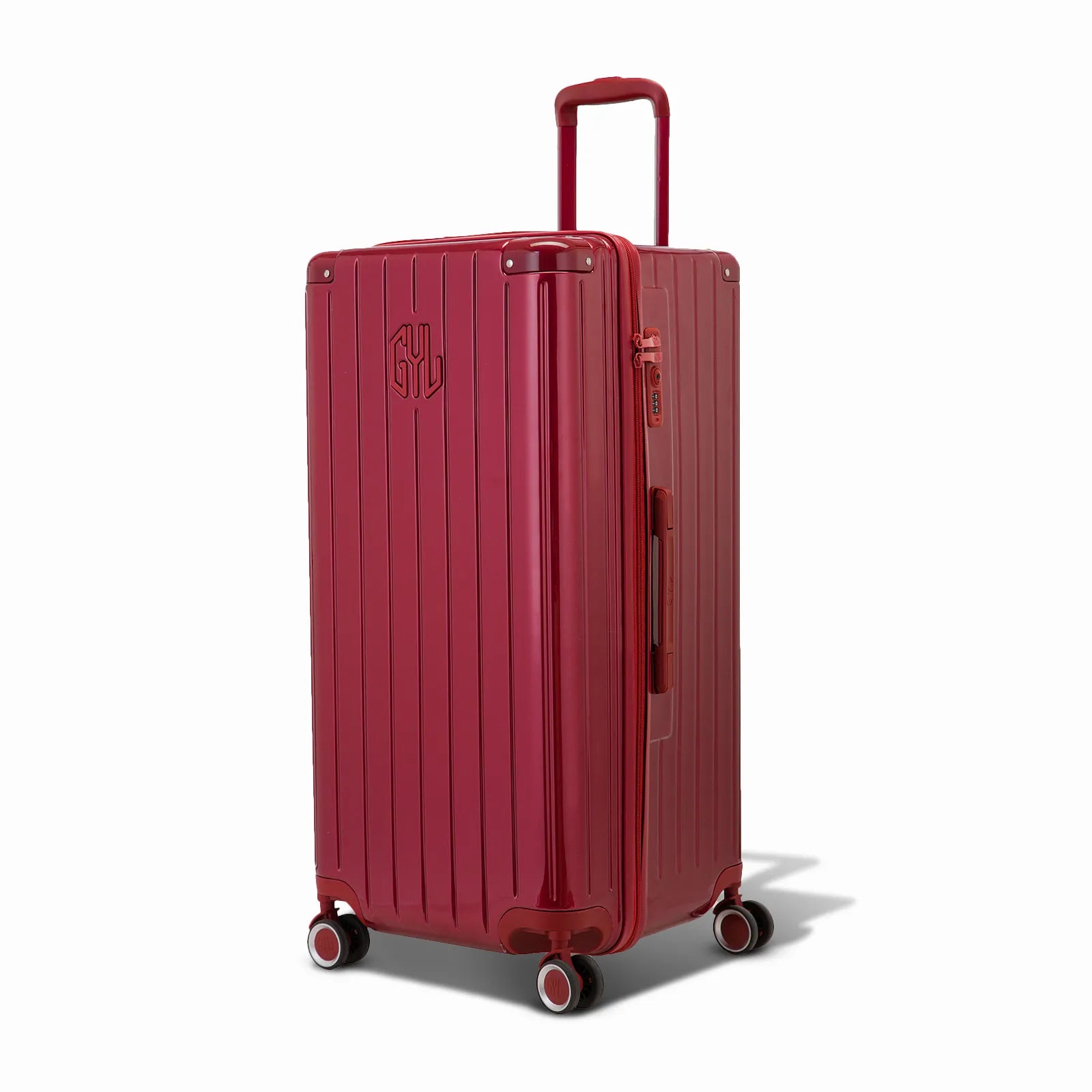 Valise trunk GYL taille XL en polycarbonate rouge foncé vue de trois quarts, avec trolley déployé et roues 360°.