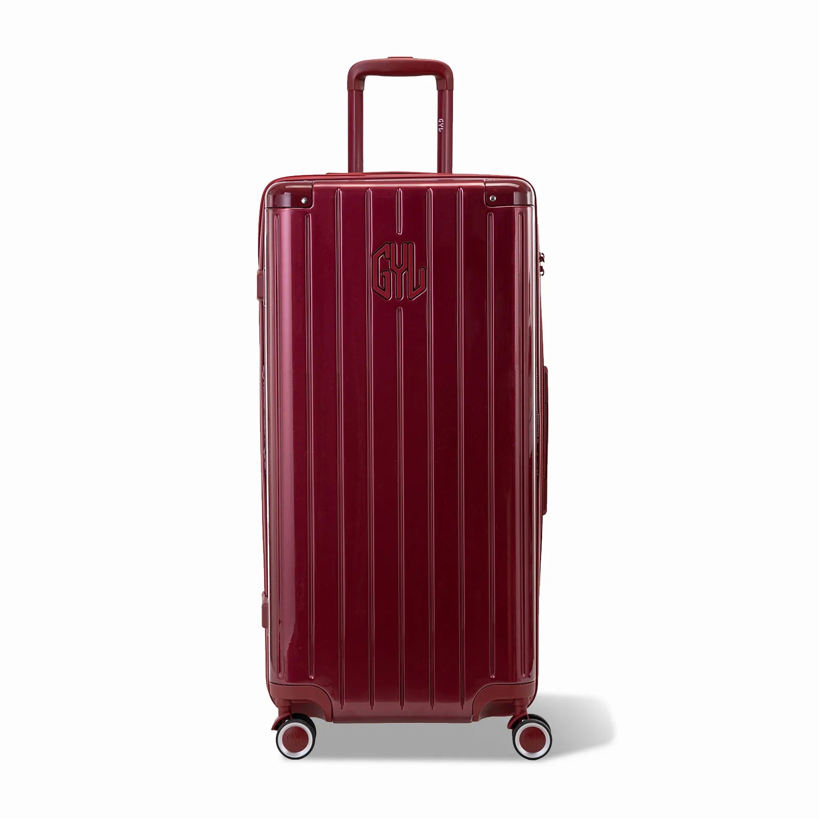 Valise trunk GYL taille XL en polycarbonate rouge foncé vue de face, avec trolley déployé et roues 360°.
