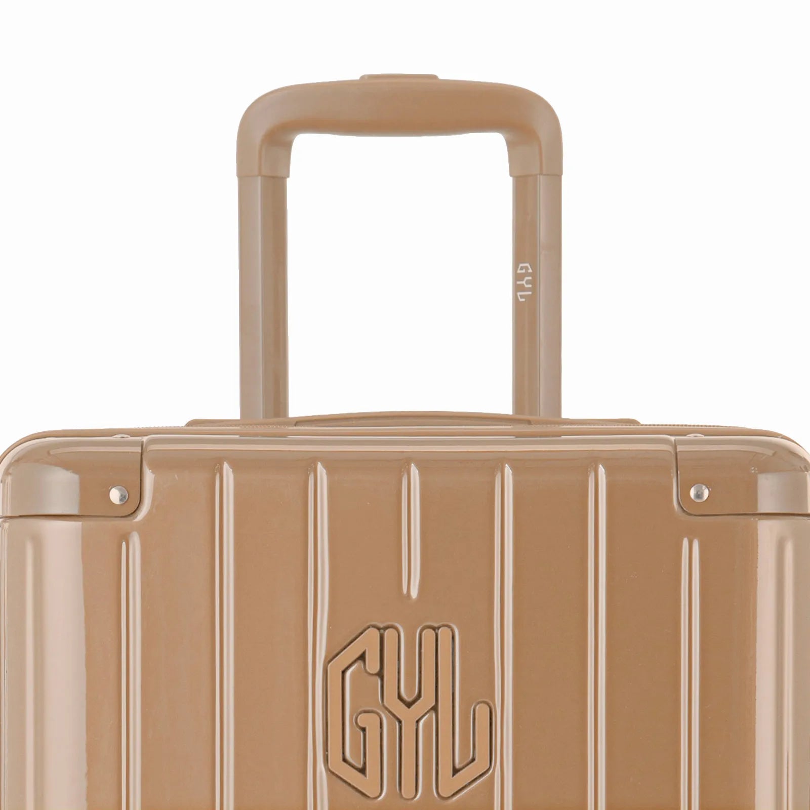 Zoom sur la poignée trolley et le logo GYL de la valise trunk champagne.