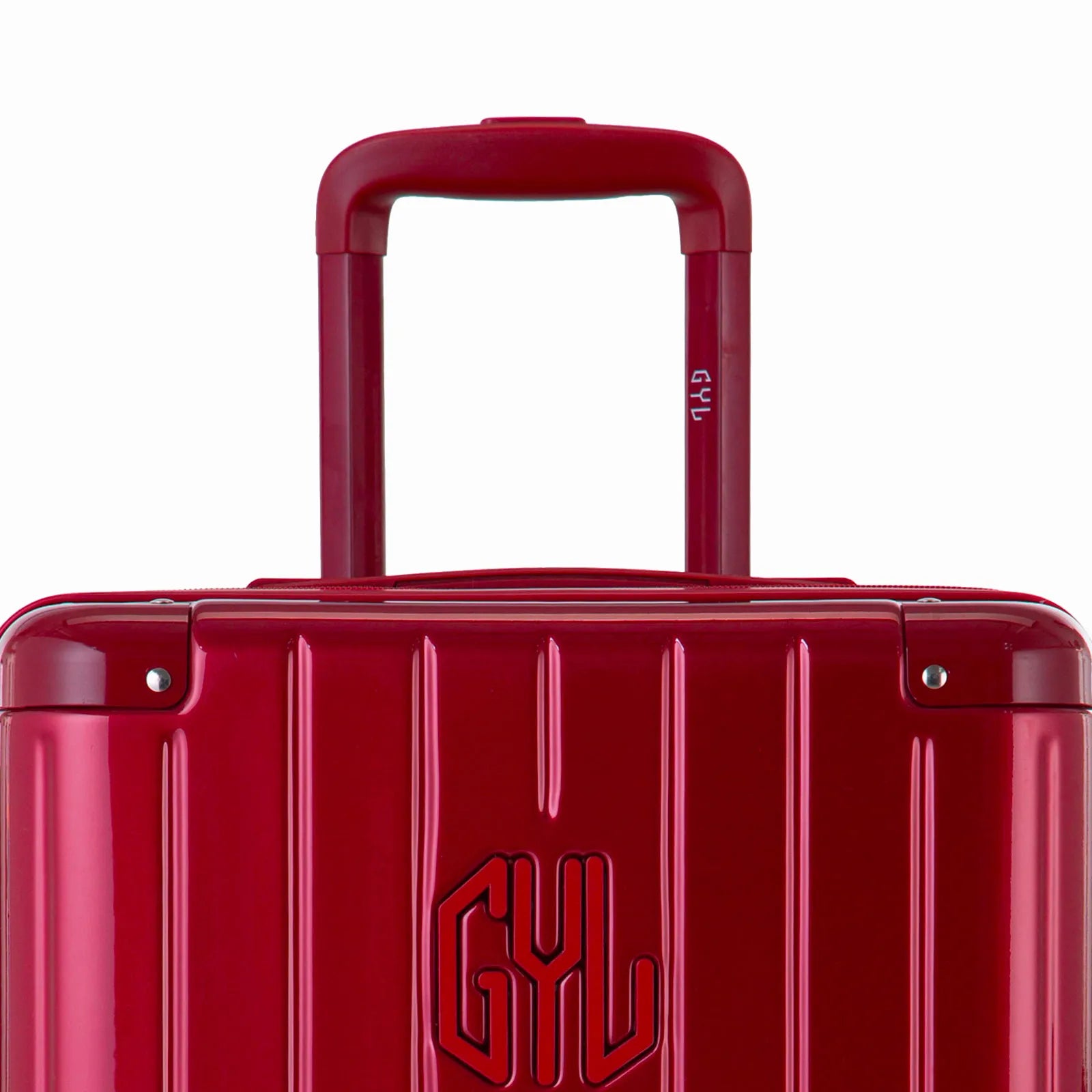 Zoom sur la poignée trolley et le logo GYL de la valise trunk rouge foncé.