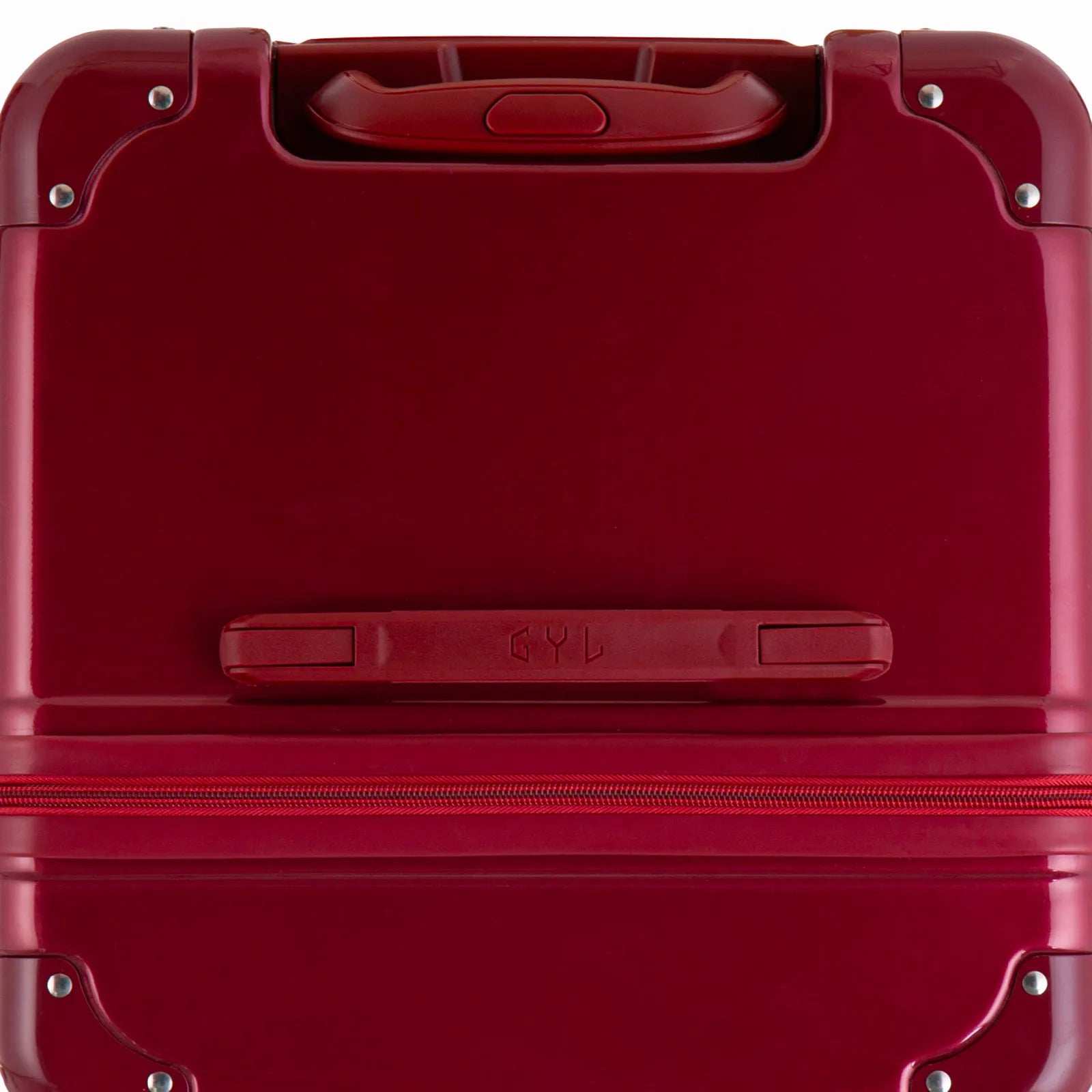 Vue du dessus de la valise trunk GYL rouge foncée en polycarbonate, avec poignée centrale et coins renforcés.