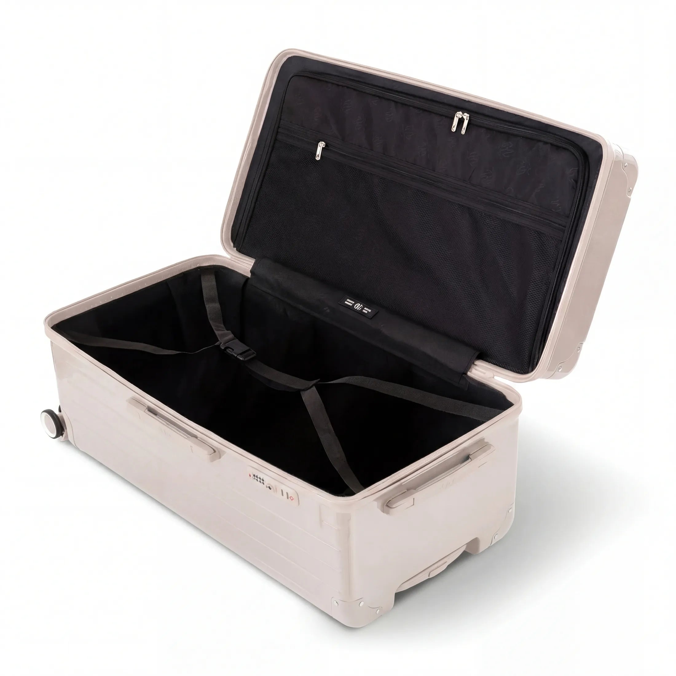 Intérieur de la valise trunk GYL XL nude ouvert, avec sangles croisées.