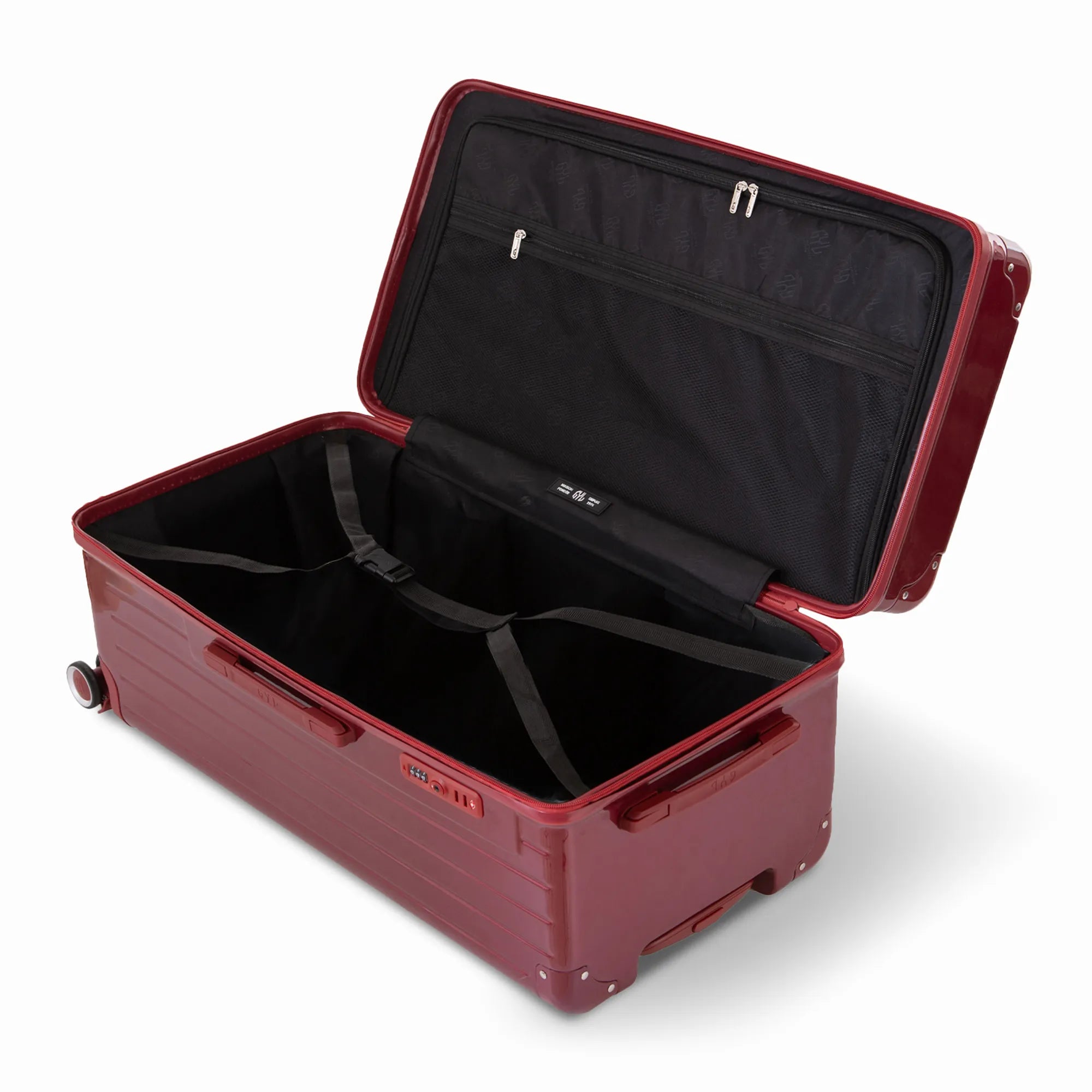 Intérieur de la valise trunk GYL XL rouge foncé ouvert, avec sangles croisées.