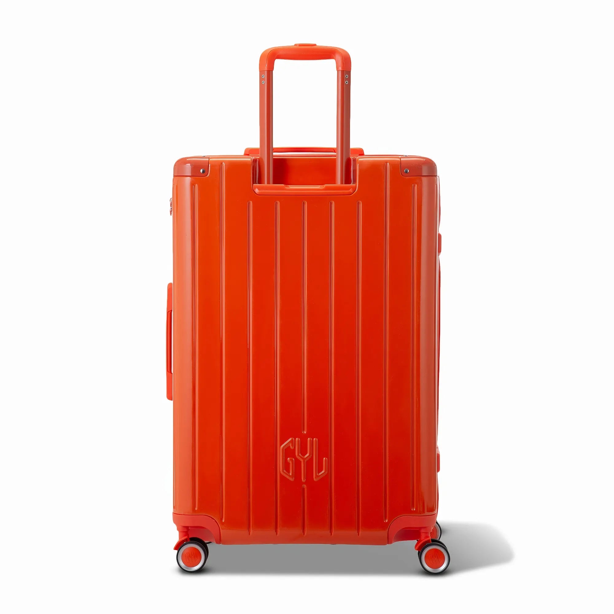 Vue arrière de la valise rigide GYL Intemporelle orange avec poignées intégrées et roulettes pivotantes.