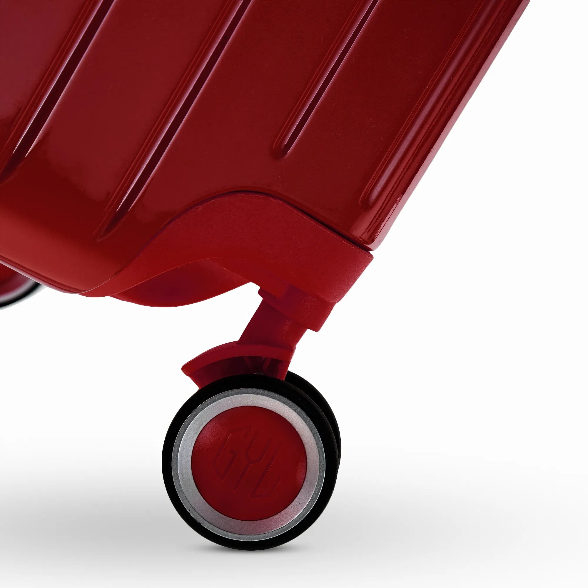 Roue double 360° de la valise GYL Intemporelle rouge foncé avec gravure du logo GYL sur le moyeu.