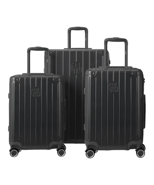 Set de 3 valises Intemporelle en polycarbonate cabine, semaine et soute coloris gris foncé glossy vue de face avec logo GYL, packshot GYL