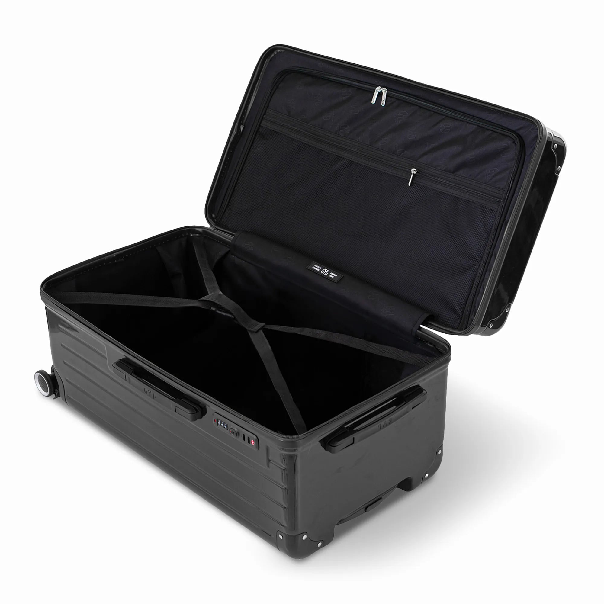 Intérieur de la valise trunk GYL L noir ouvert, avec sangles croisées.
