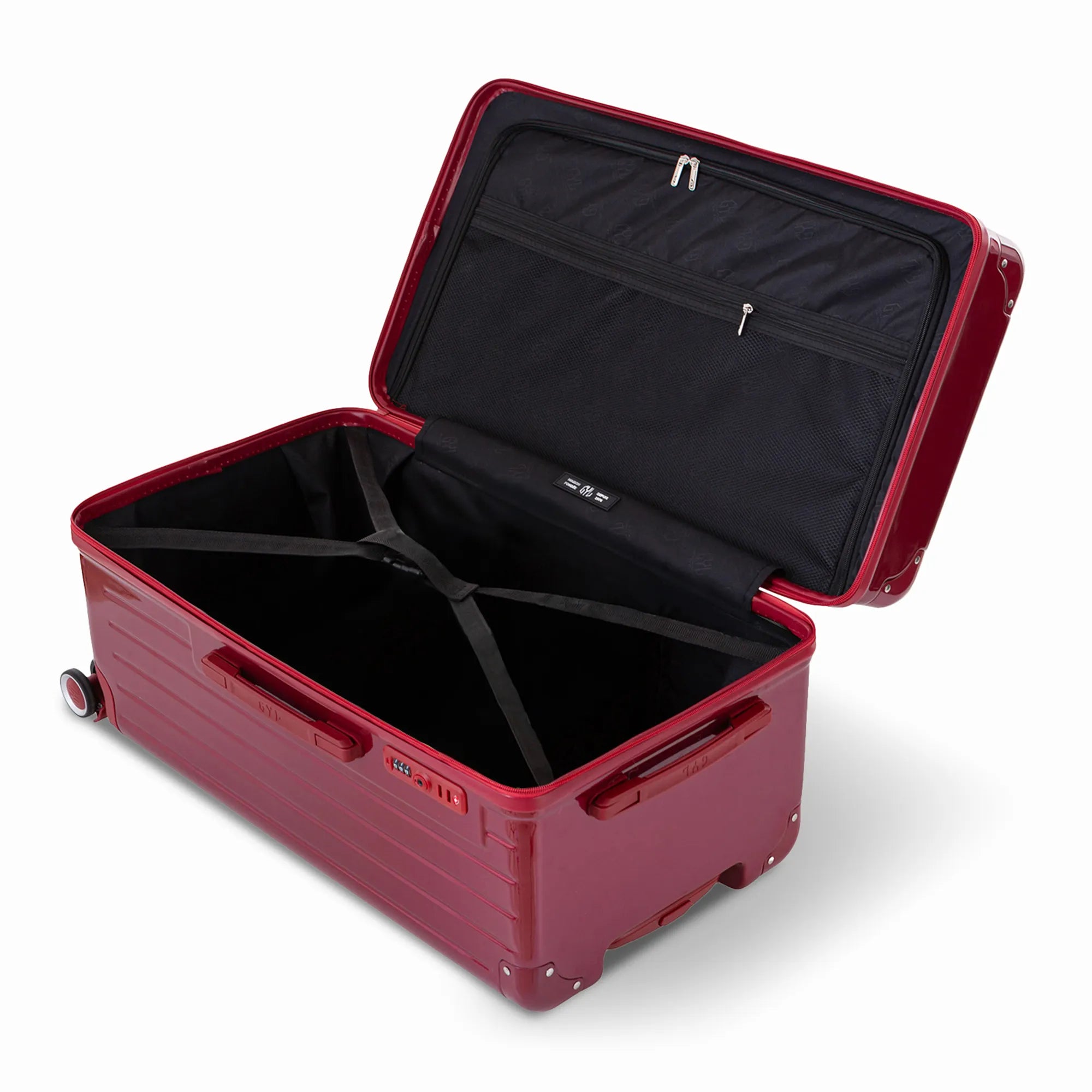 Intérieur de la valise trunk GYL L rouge foncé ouvert, avec sangles croisées.