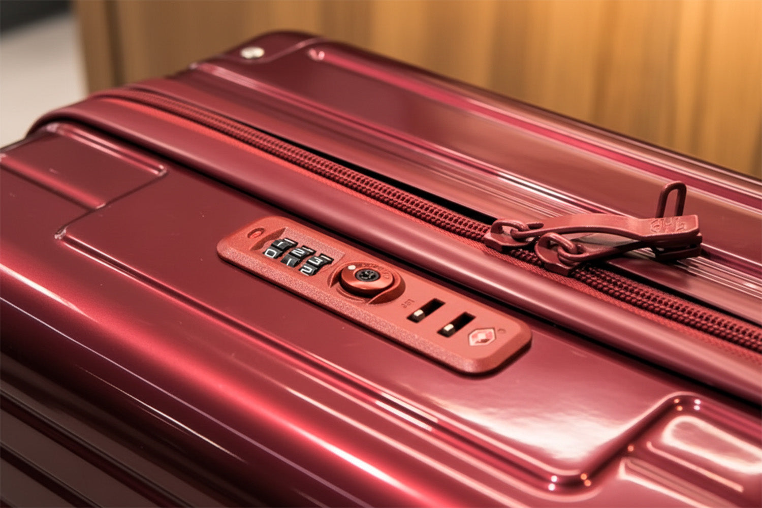 Cadenas TSA d’une valise GYL rouge avant le changement de code, avec les curseurs non insérés dans la serrure