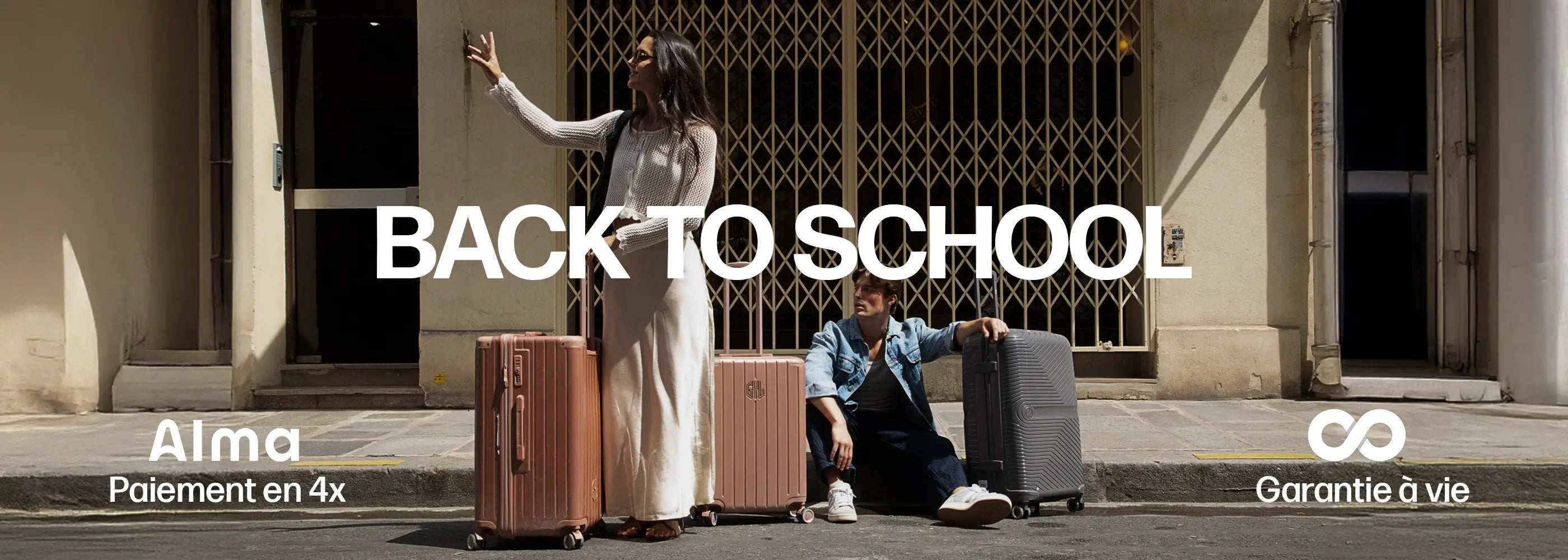 Promotion rentrée Back to School GYL : femme et homme avec valises rigides GYL rose et grise devant un immeuble, offre paiement en 4x et garantie à vie.