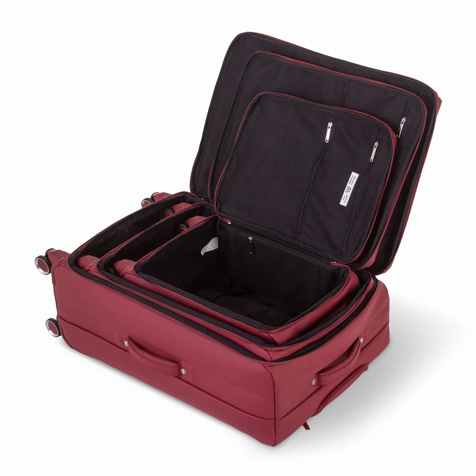 Ensemble de trois valises GYL Évasion en polyuréthane rouge foncé, ouvertes et imbriquées les unes dans les autres pour montrer leur conception pratique et leur intérieur spacieux.