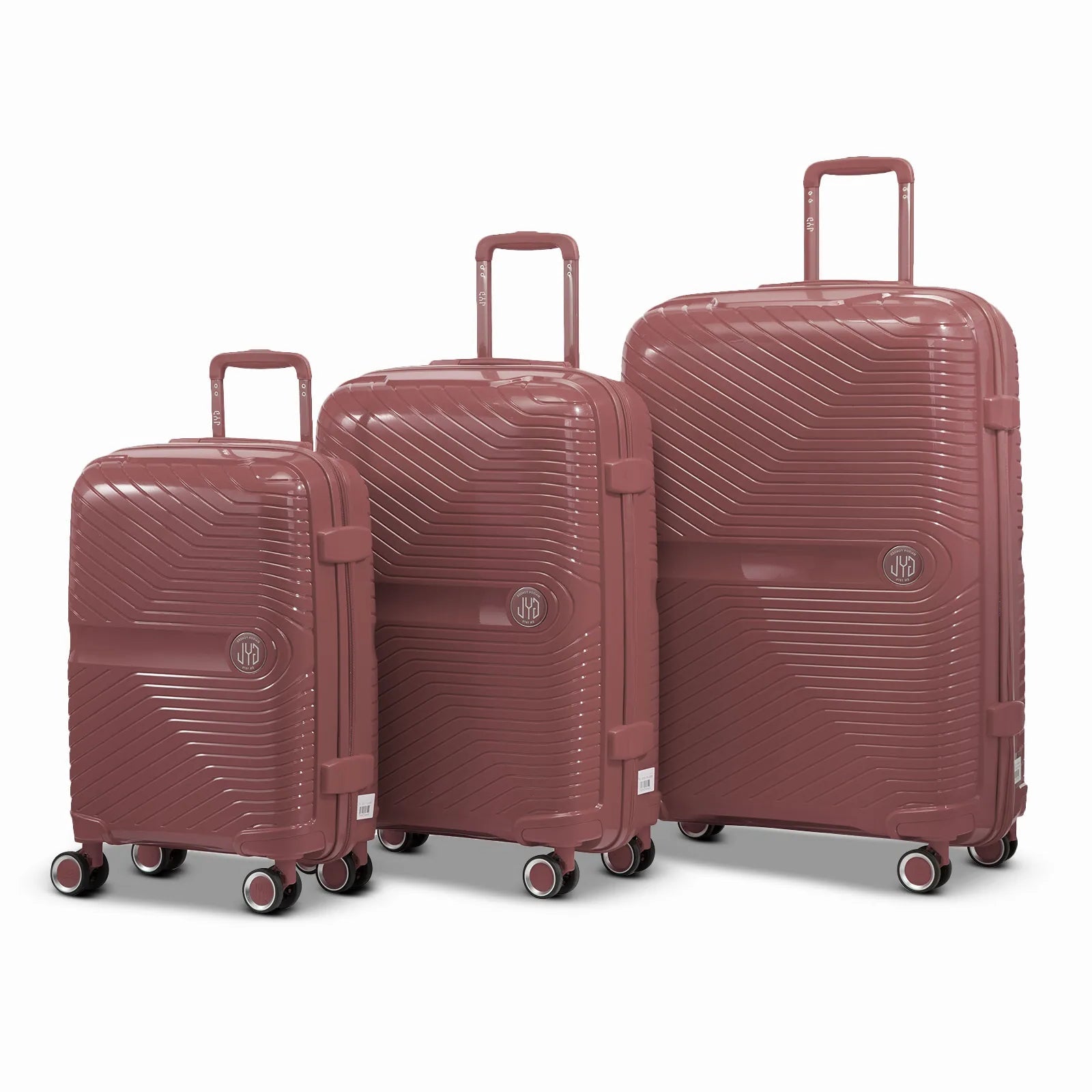 Ensemble de trois valises GYL Signature en polypropylène rose gold, comprenant les formats cabine, moyenne et soute, avec trolley télescopique et roues doubles 360°.