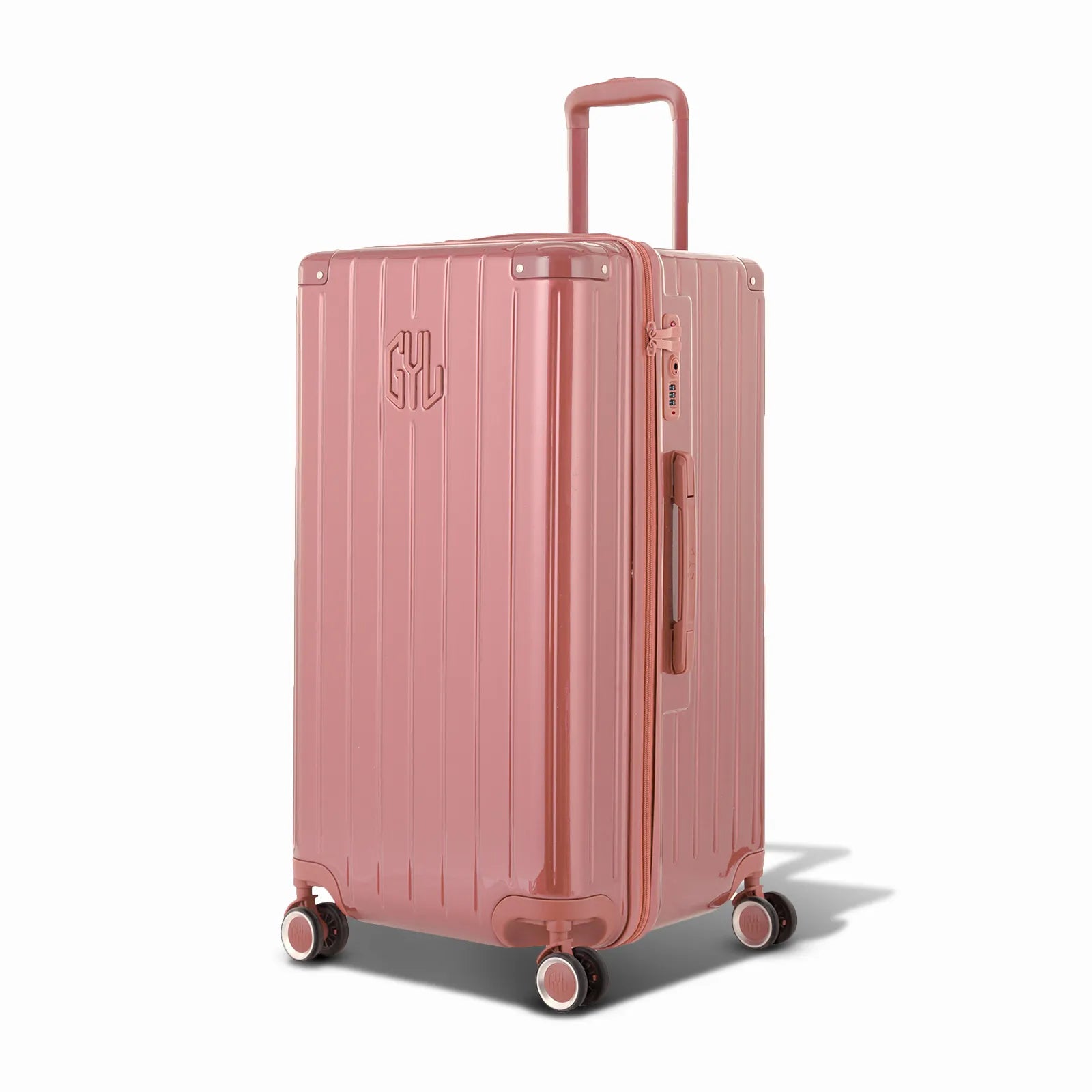 Valise trunk GYL taille L en polycarbonate rose gold vue de trois quarts, avec trolley déployé et roues 360°