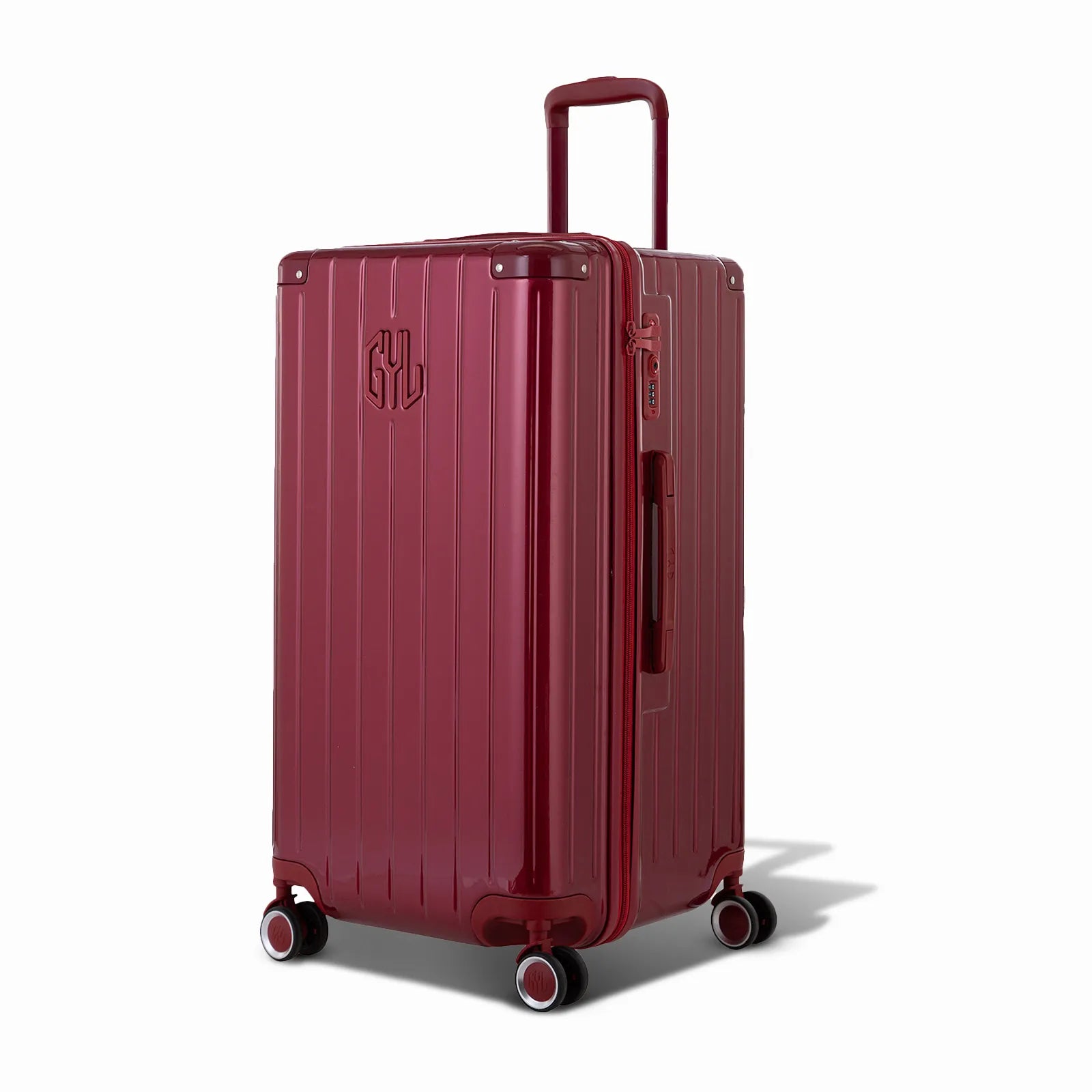 Valise trunk GYL taille L en polycarbonate rouge foncé vue de trois quarts, avec trolley déployé et roues 360° #couleur_rouge foncé