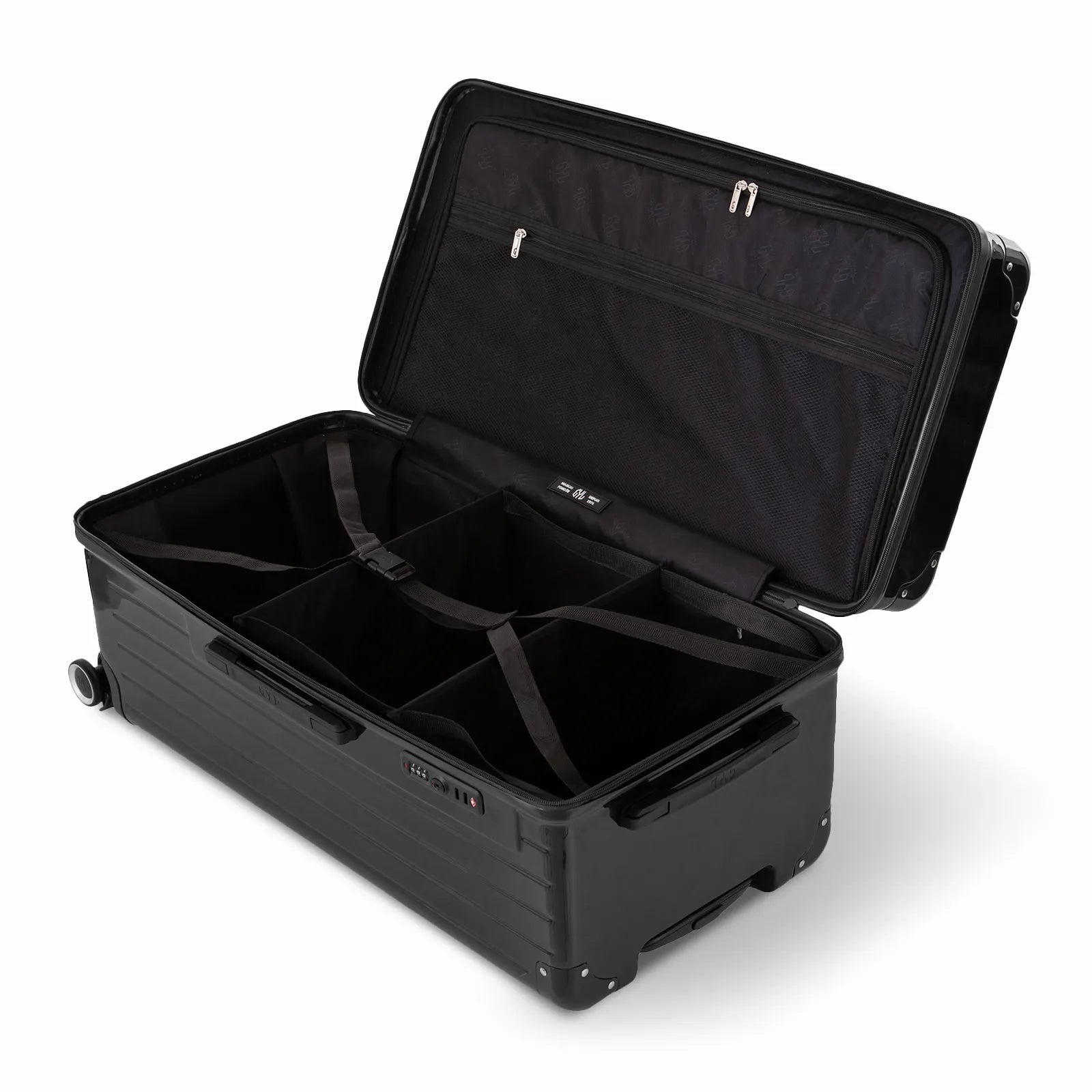 Intérieur de la valise trunk GYL XL noir ouvert, avec sangles croisées et compartiments de rangement.