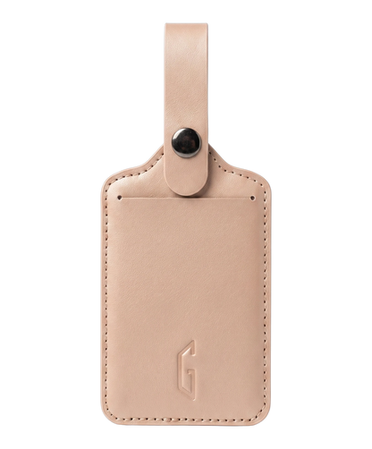 Etiquette de bagage GYL en cuir coloris rose gold, porte-adresse avec logo G embosse et bouton pression metallique