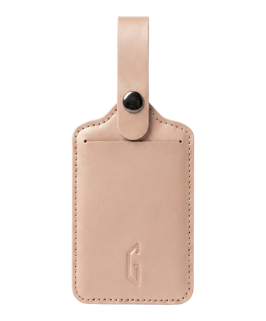 Etiquette de bagage GYL en cuir coloris rose gold, porte-adresse avec logo G embosse et bouton pression metallique