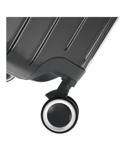 Valise Intemporelle en polycarbonate coloris gris foncé glossy gros plan sur la roulette pivotante silencieuse avec logo GYL, packshot GYL