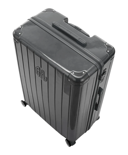 Valise rigide Intemporelle gris fonce vue de dos avec poignees integrees et roulettes pivotantes GYL