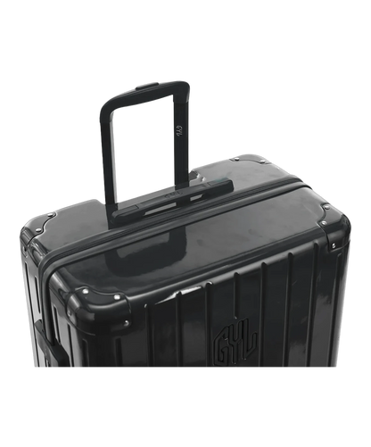 Valise Intemporelle en polycarbonate coloris gris foncé glossy vue de dessus avec trolley télescopique en aluminium et logo GYL, packshot GYL