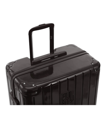 Valise rigide Intemporelle noir vue de dos avec poignees integrees et roulettes pivotantes GYL