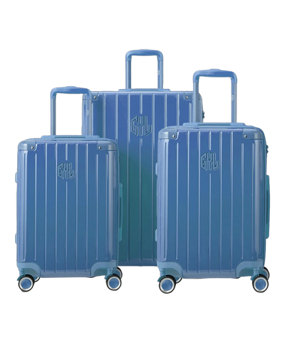 Set de 3 valises rigides Intemporelle en polycarbonate coloris bleu grise vue de face avec logo GYL