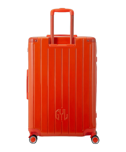 Valise rigide Intemporelle orange fonce vue de dos avec poignees integrees et roulettes pivotantes GYL