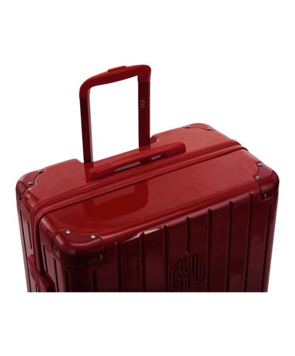 Poignee trolley telescopique GYL deployee sur la valise Intemporelle rouge fonce en polycarbonate