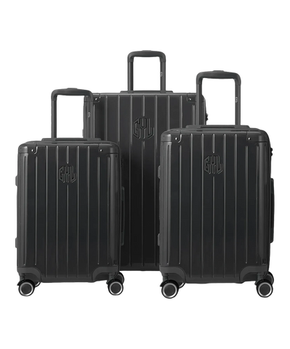 Set de 3 valises Intemporelle en polycarbonate cabine, semaine et soute coloris gris foncé glossy vue de face avec logo GYL, packshot GYL