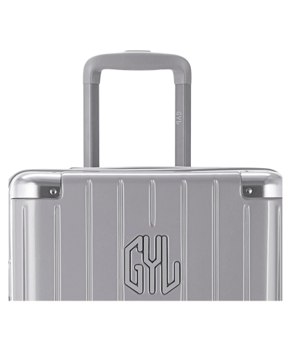 Valise Trunk L Intemporelle GYL en polycarbonate 71 cm coloris argent gros plan sur la poignee trolley et les coins renforces