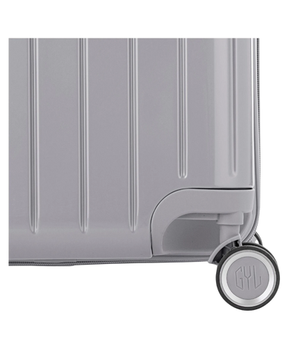 Valise Trunk L Intemporelle GYL en polycarbonate 71 cm coloris argent gros plan sur une roulette double 360 degres siglee GYL