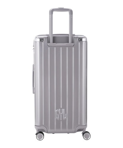 Valise Trunk L Intemporelle GYL en polycarbonate 71 cm coloris argent vue de dos avec trolley telescopique deploye